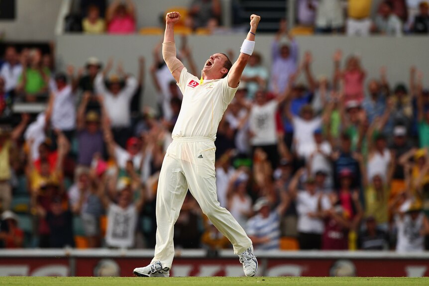 Australia bowler clenches both fists in the air as he celebrates an Ashes Test hat-trick against England at the Gabba in 2010.