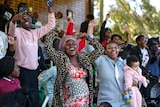 African Australian fans cheer and celebrate in the grandstand