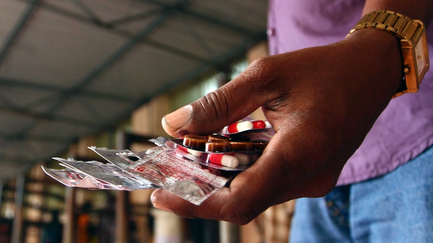 Indian patient holds government-provided medicine