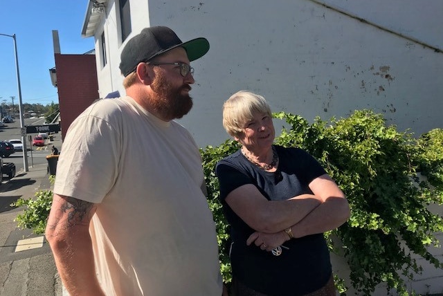 Mural artist Smug discusses his latest work in North Hobart with a local resident