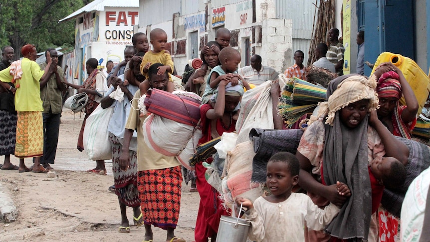 Displaced Somalis flee the Badbado settlement in Mogadishu
