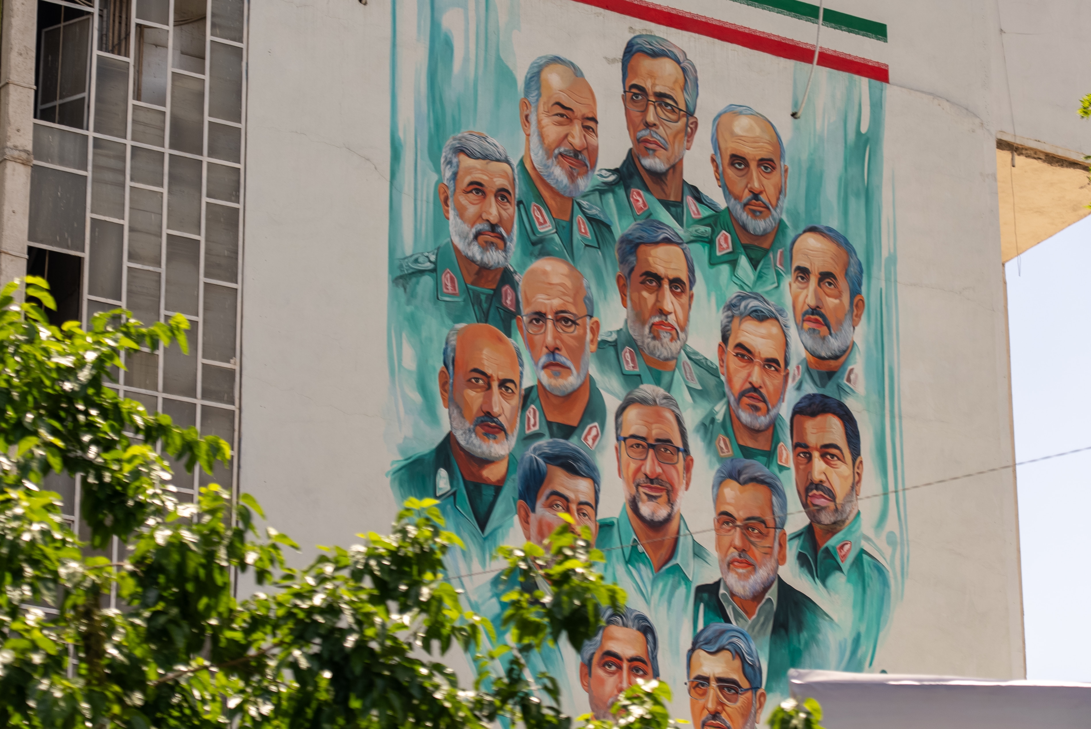 A mural on the side of a building depicting senior Iranian military commanders.