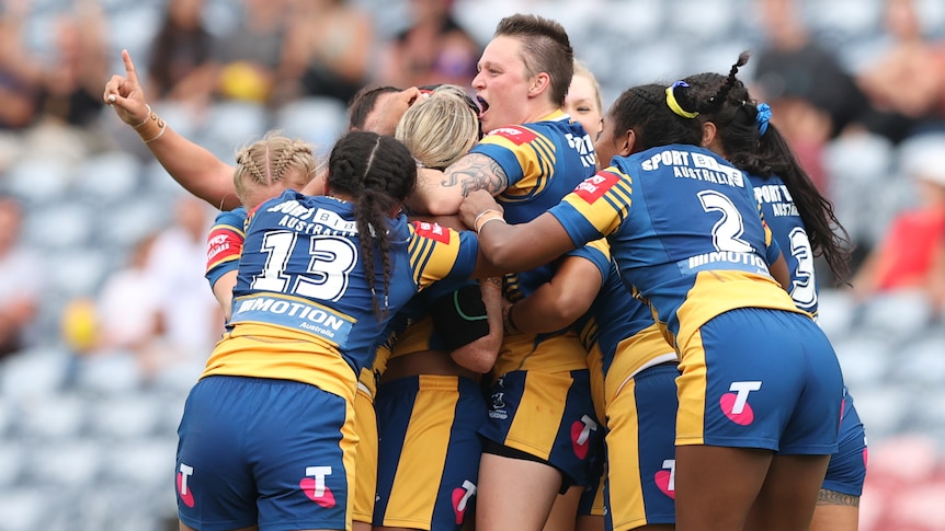 A group of Parramatta Eels NRLW players celebrate beating the Newcastle Knights.
