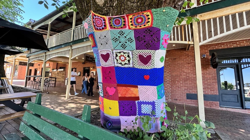 tree outside Royal Hotel in Daylesford covered by knitted squares