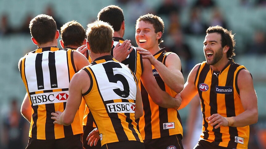 The Hawks celebrate another goal against the Giants at the MCG.