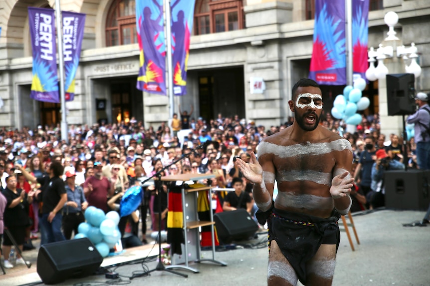 An Aboriginal dancer performs on stage at the Perth rally for Cassius.