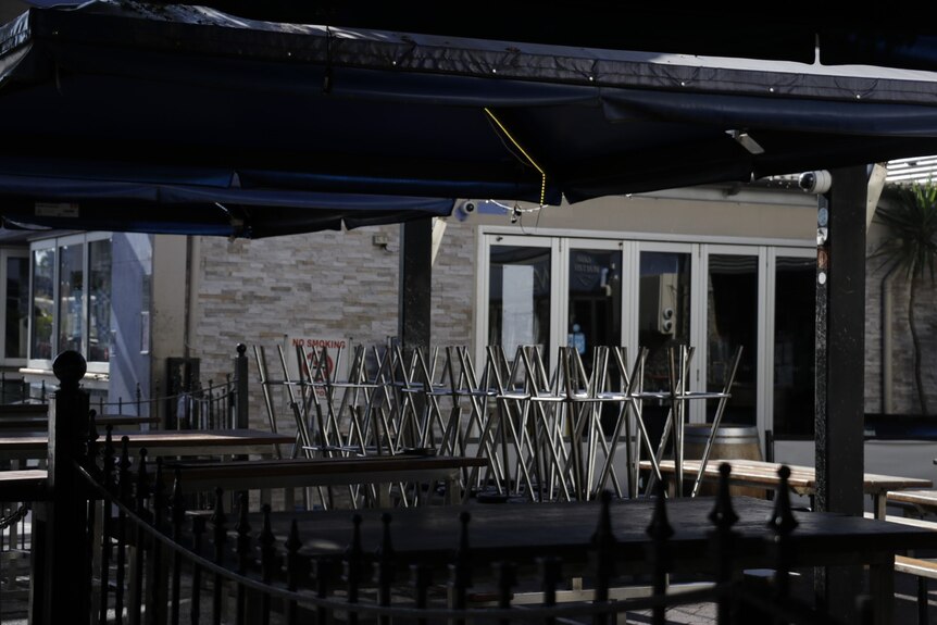 Chairs are seen placed on tables on Darwin's main pub and bar strip on Mitchell St.