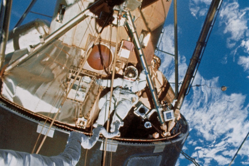 Astronaut Edward Gibson performs a space walk on Skylab space station.