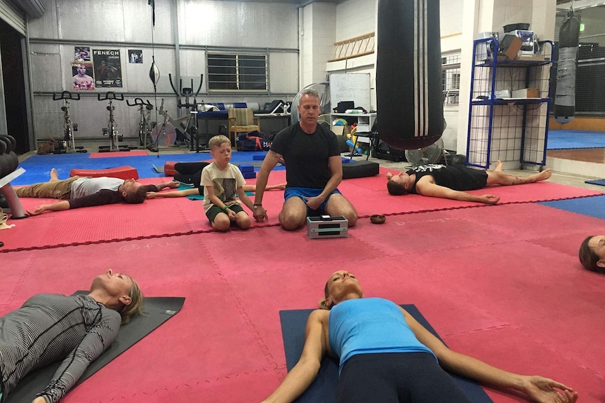 Former army medic Charles Stevenson (centre) runs free yoga classes for military veterans and family members