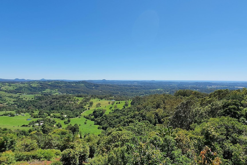 View from a mountain range across to the ocean.