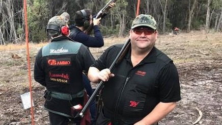 Adam Brooks and other shooters at a gun target range.