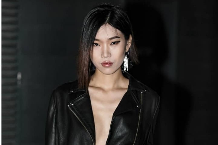 Chinese woman modeling in blakc leather jacket