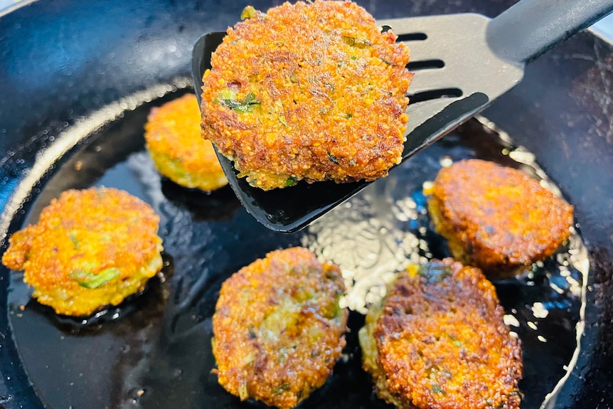 Golden lentil patties fry in a pan