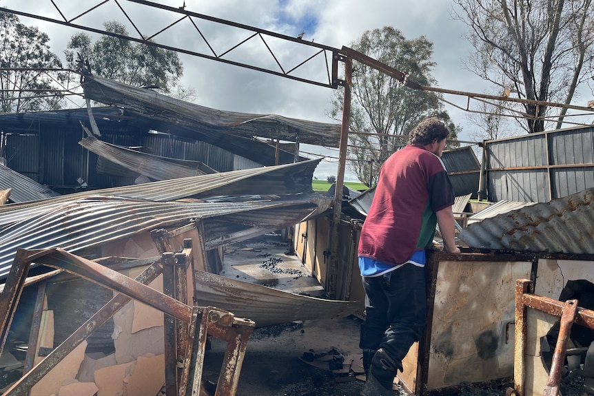 Corrigin farmer Steven Bolt with one of his sheds destroyed by bushfire