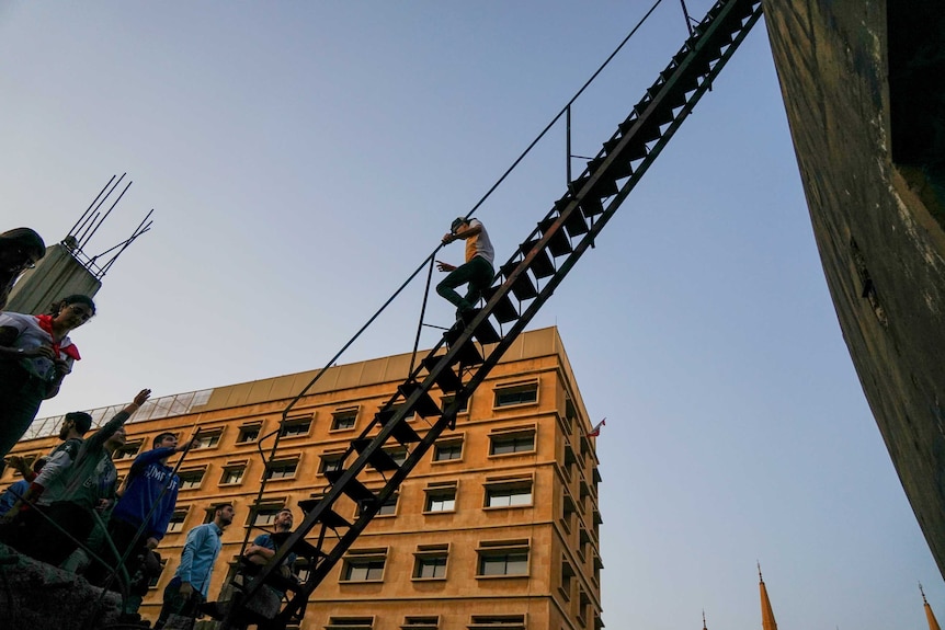 A man climbing down the stairs from the Egg theatre in Beirut