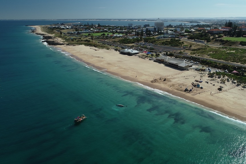 A drone shot of an inflatable reef being installed off a gorgeous-looking WA beach.