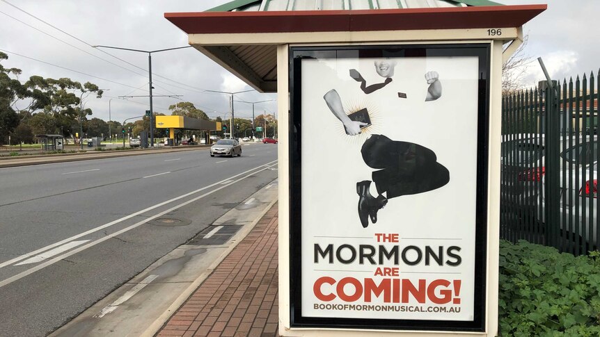Poster promoting the musical the Book of Mormon on an Adelaide bus shelter.