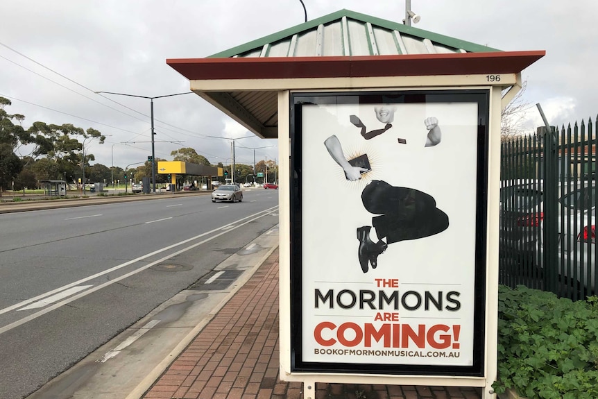 Poster promoting the musical the Book of Mormon on an Adelaide bus shelter.