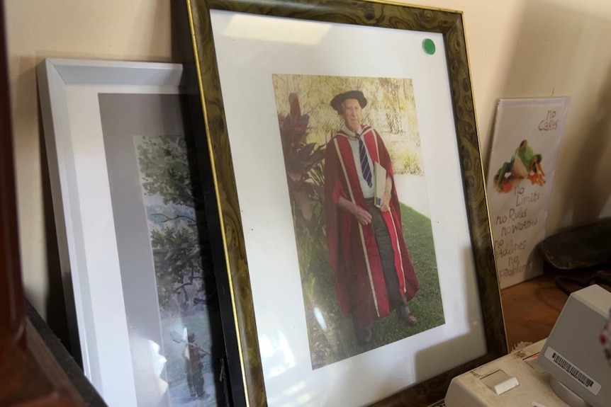 A framed photo of a man in university robes 