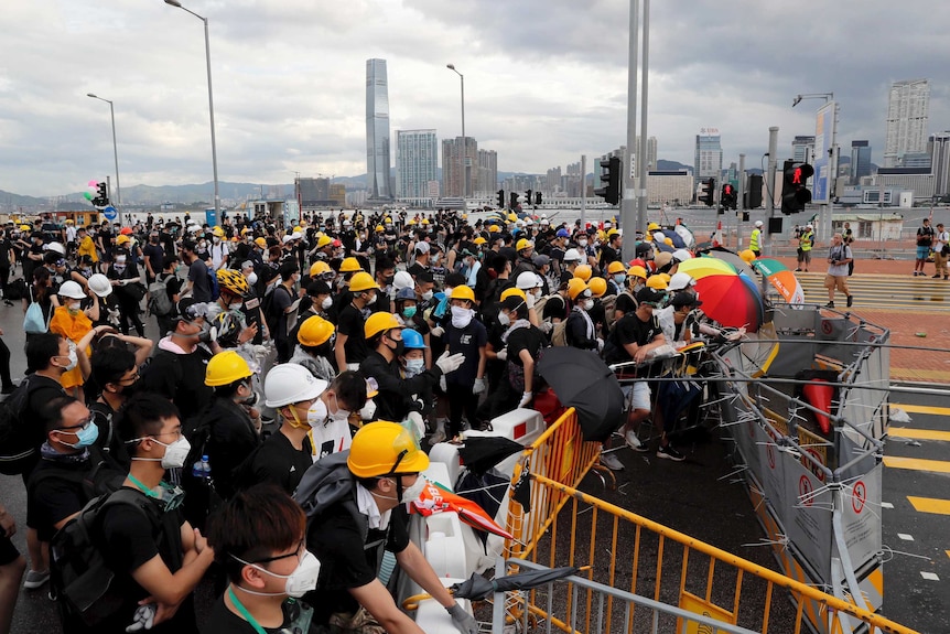 Protesters place barricades across a road in Hong Kong.