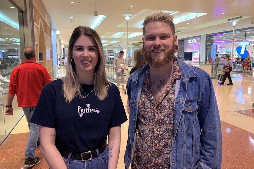 Retail workers Talia Goodliffe and Chris Stewart standing inside Marion Shopping Centre.