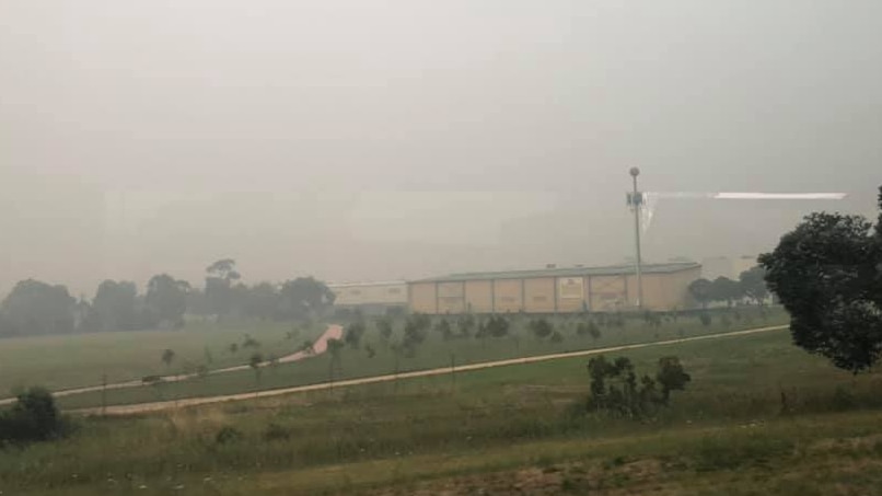 Heavy smoke pollution looks like fog over a paddock in Dandenong.
