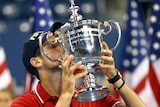 Novak Djokovic kisses the US Open trophy