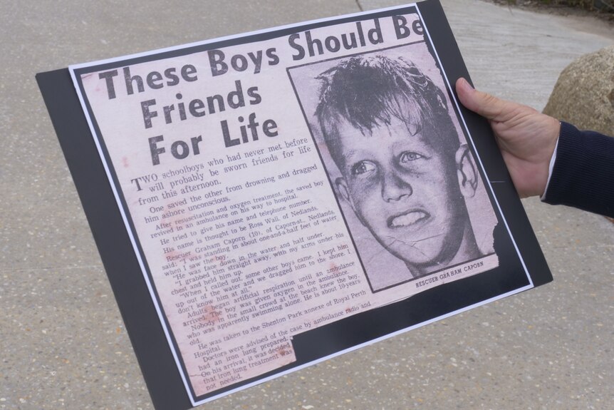 A physical print of the newspaper article titled "these boys should be friends for life"