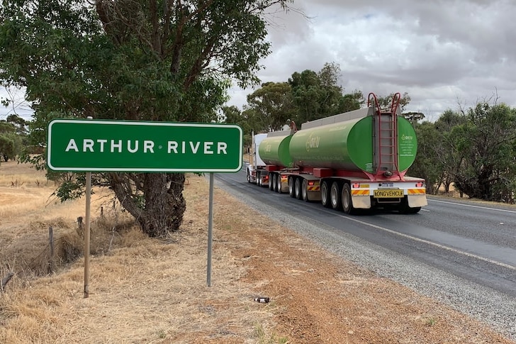 'Arthur River' sign as road train passes