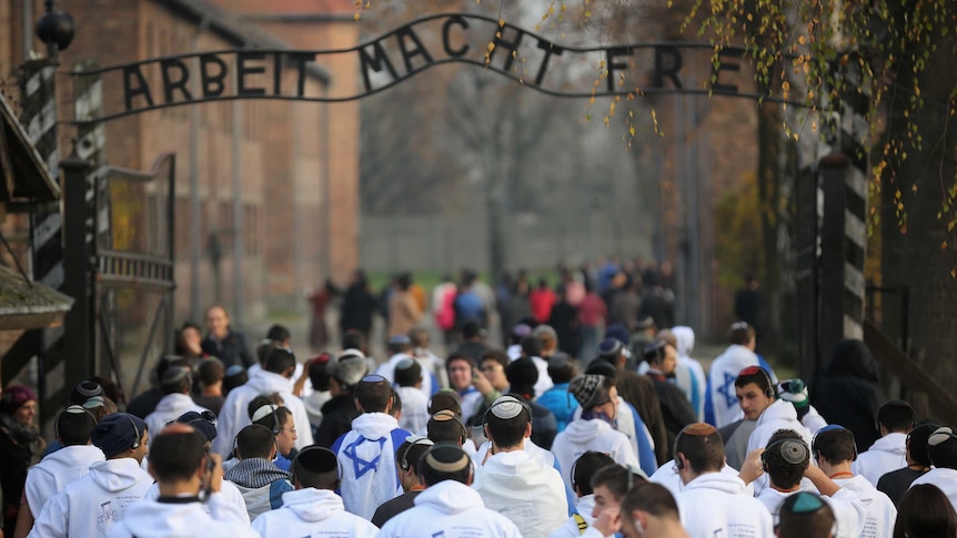 Young Israelis walk through the gates of Auschwitz.