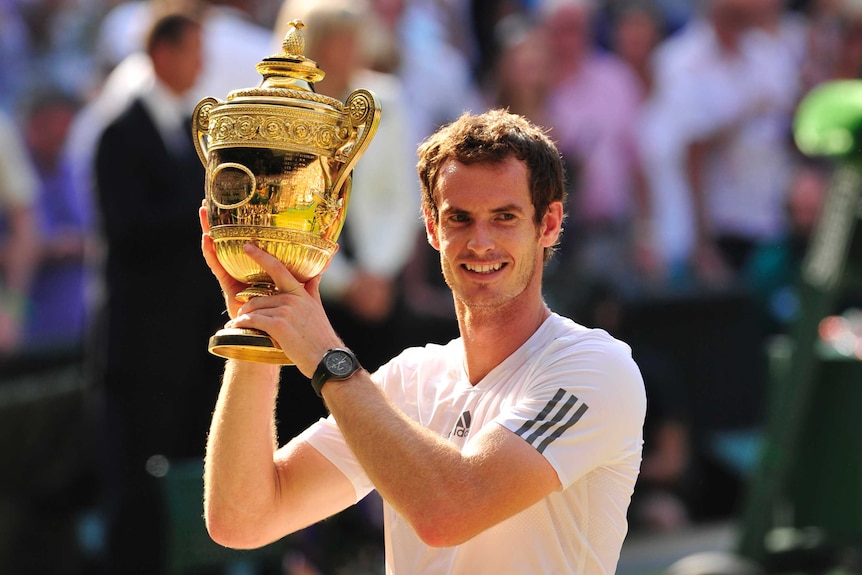 Britain's Andy Murray raises the winner's trophy after beating Serbia's Novak Djokovic in the Wimbledon final