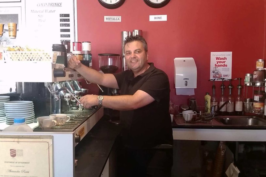 Alessandro Parisi serves coffee to customers