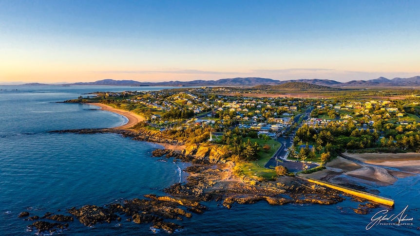 an aerial view of a beachside town at daybreak