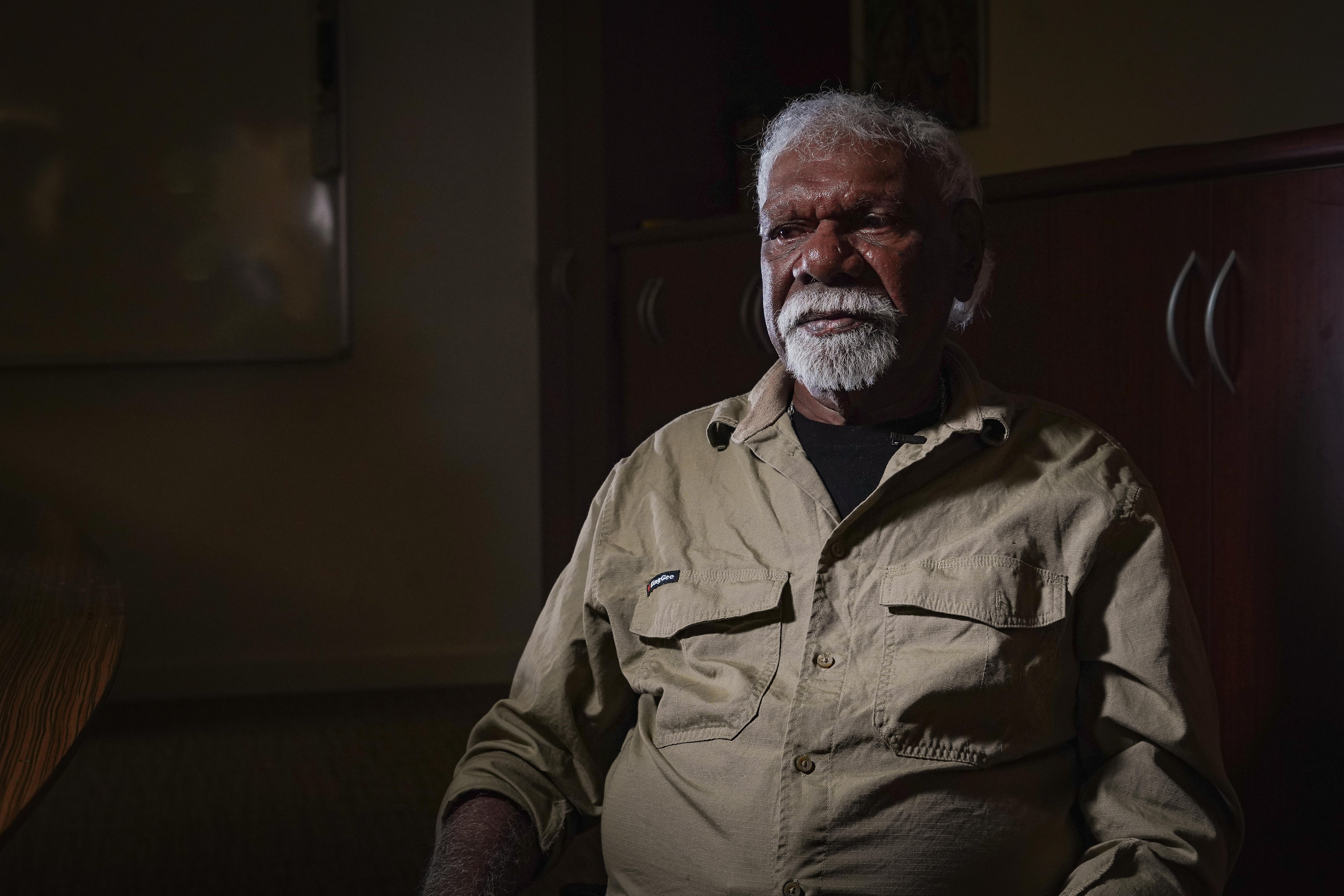 A man in an olive shirt with a goatee