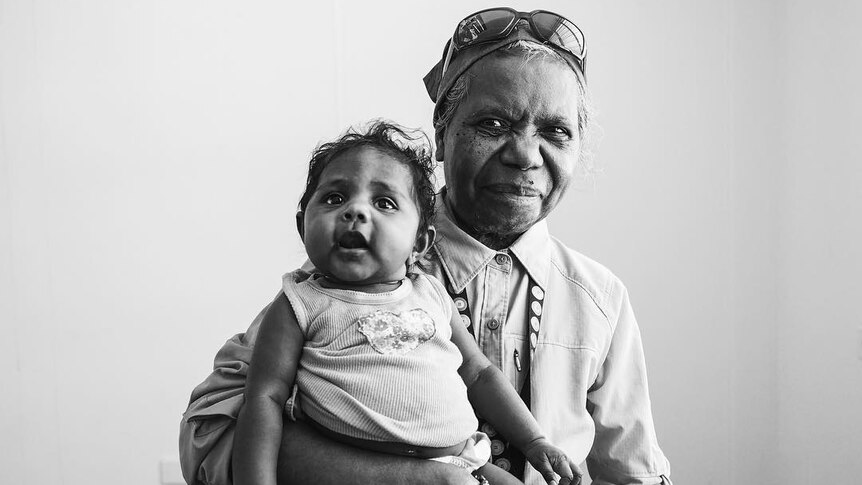 An indigenous elder with her grand daughter.