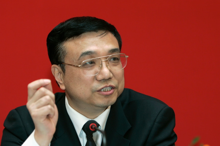 China's Premier Li Keqiang speaking against a red background 