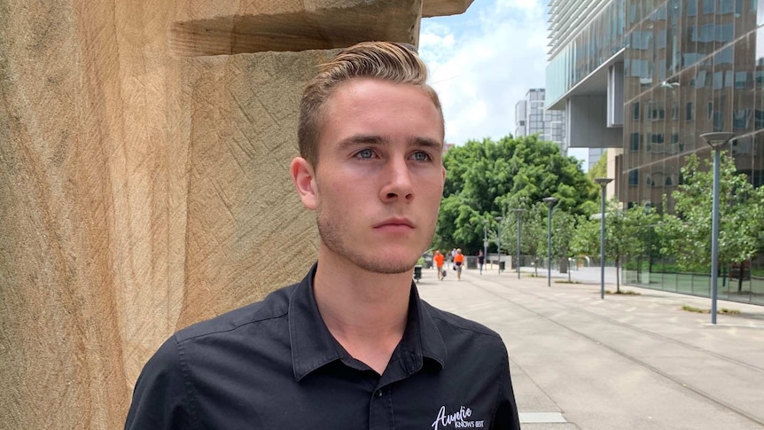 A man in a cafe uniform.