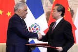Dominican Foreign Minister Miguel Vargas, left, shake hands with Chinese Foreign Minister Wang Yi.