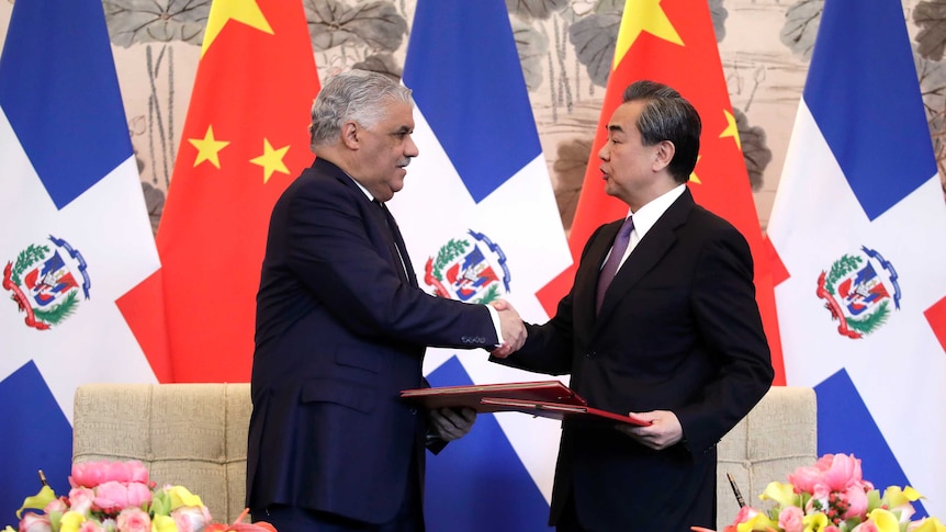 Dominican Foreign Minister Miguel Vargas, left, shake hands with Chinese Foreign Minister Wang Yi.