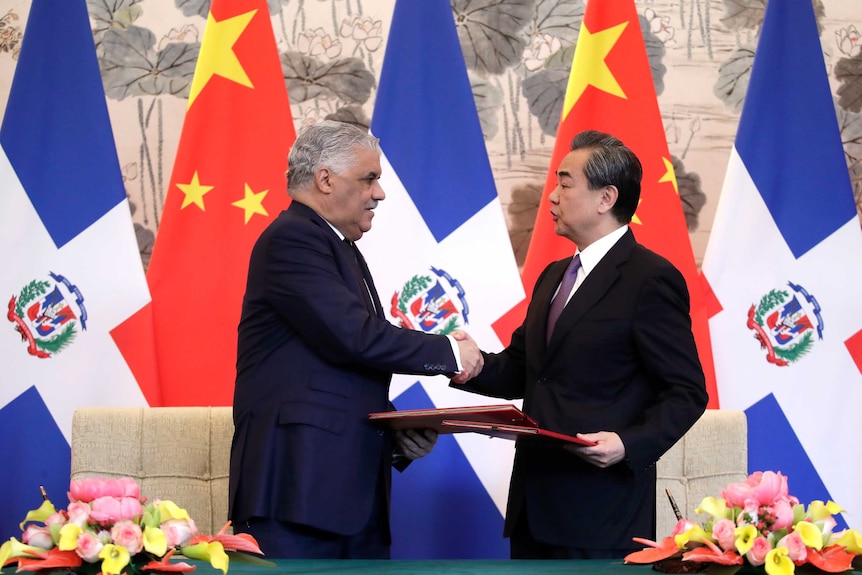 Dominican Foreign Minister Miguel Vargas, left, shake hands with Chinese Foreign Minister Wang Yi.