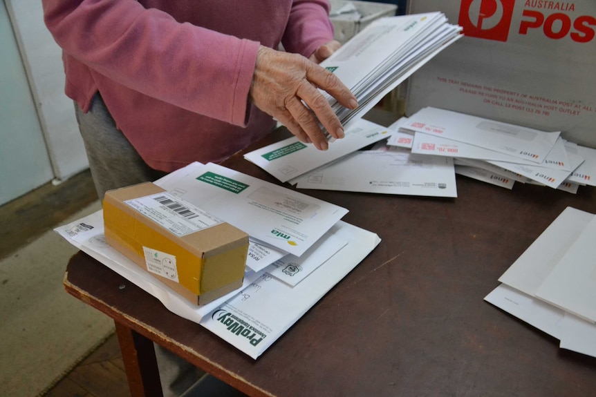 A woman sorts through mail