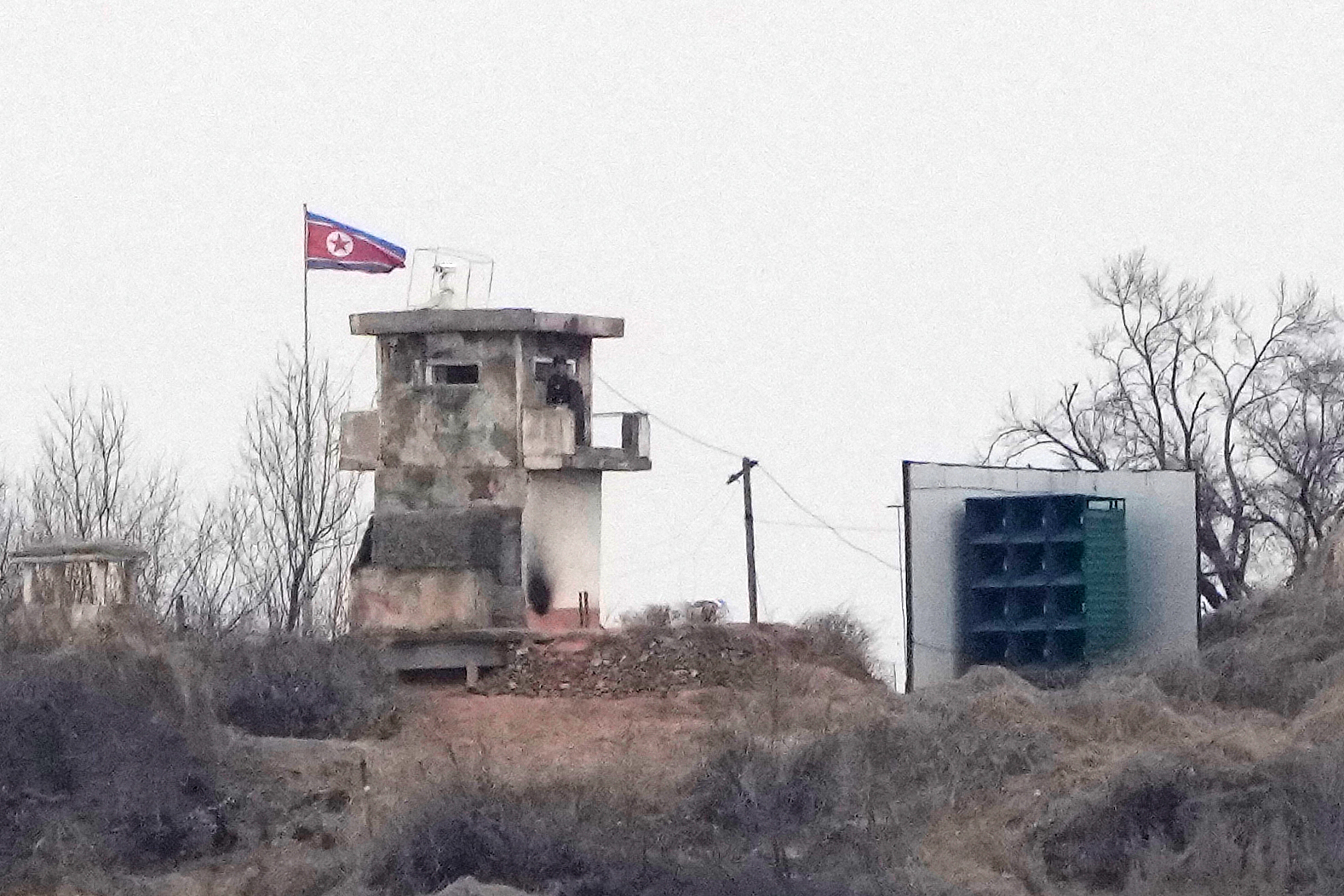 A cement military block with the North Korea flag flying next to it.