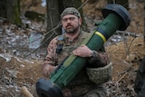 A Ukrainian service member holds a Javelin missile system.
