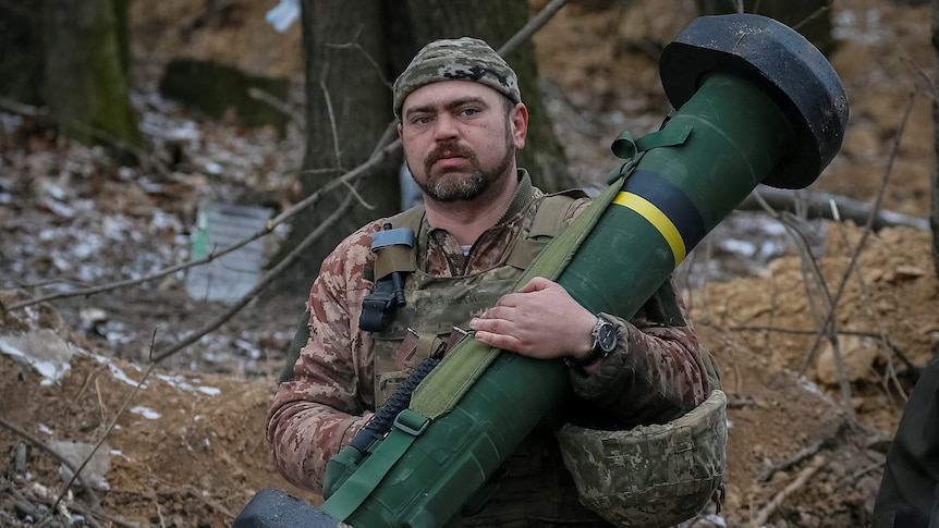 A Ukrainian service member holds a Javelin missile system.