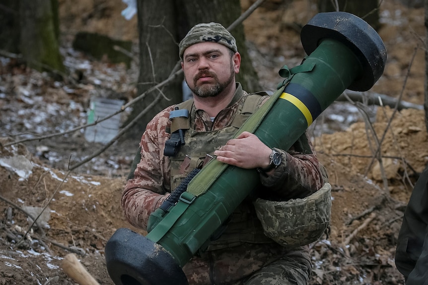 A Ukrainian service member holds a Javelin missile system.