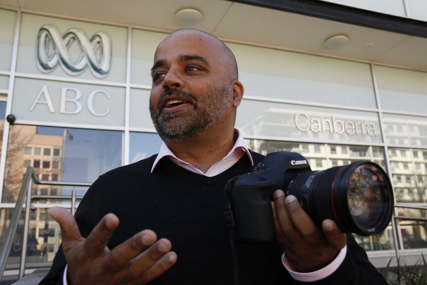 Vishal Pandey holds a camera.