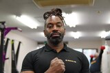 A portrait photo of Maurice Shelton inside a gym.