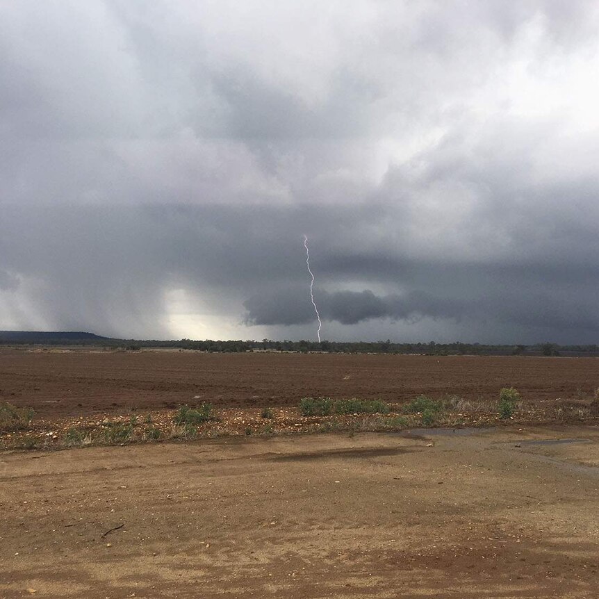 Lightning strike and storm clouds in the distance at a farm at drought-stricken Dululu, west of Gladstone.