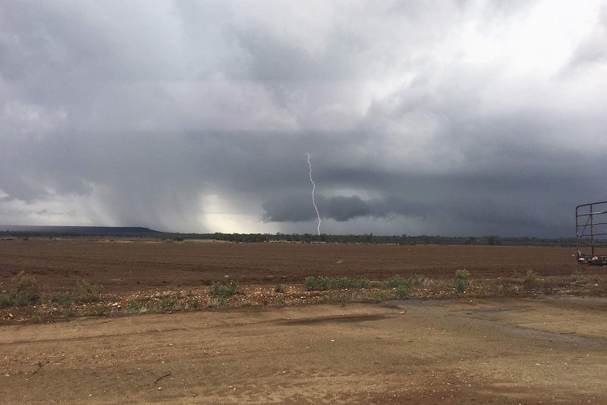 Lightning strike and storm clouds in the distance at a farm at drought-stricken Dululu, west of Gladstone.