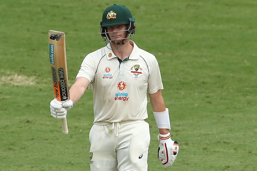 Australia's Steve Smith raises his bat in acknowledgement after making a Test half-century.